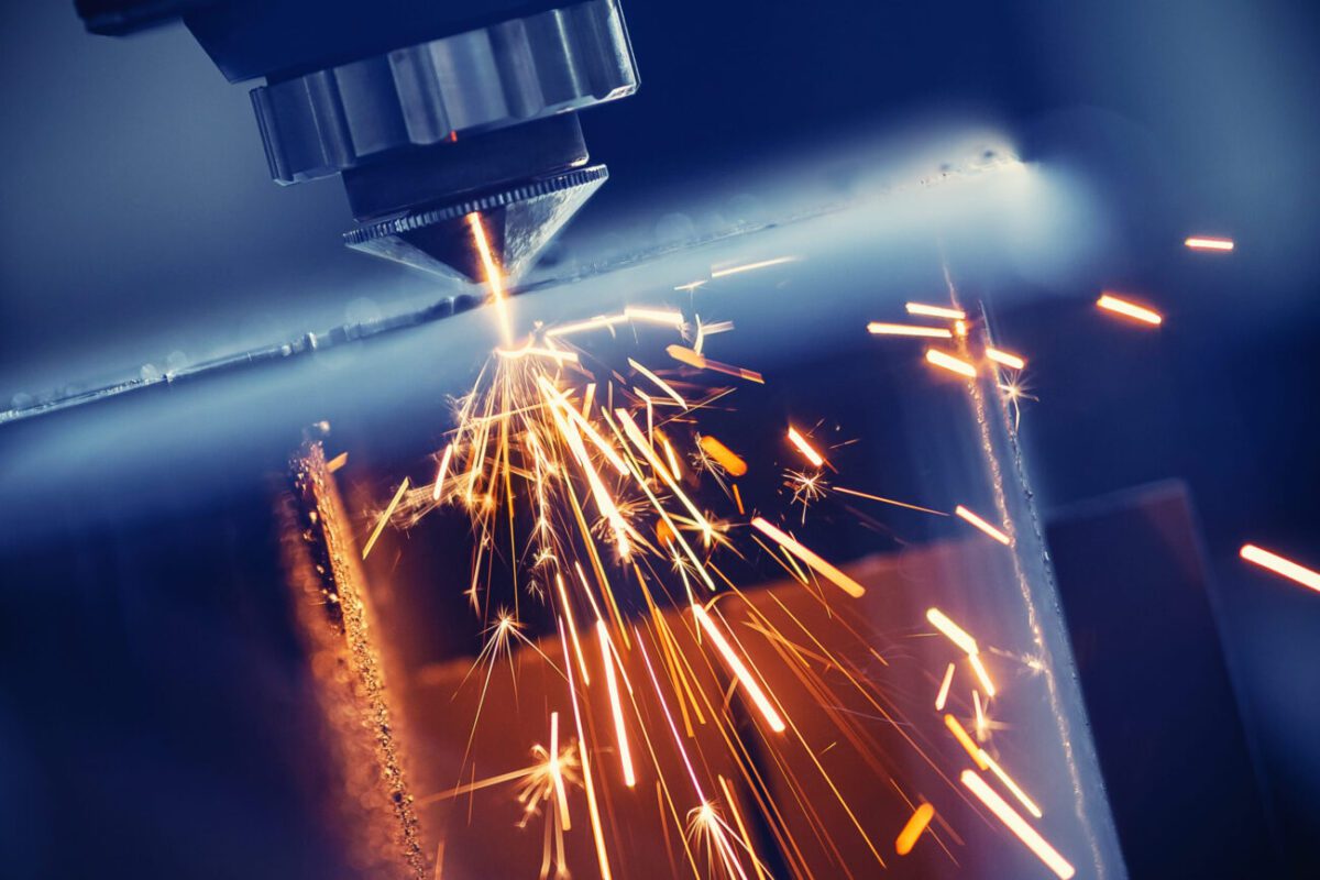 784332 Sandoval Martinez | diario-economia.com Industrial laser cutter sparks fly as it cuts through a metal sheet.